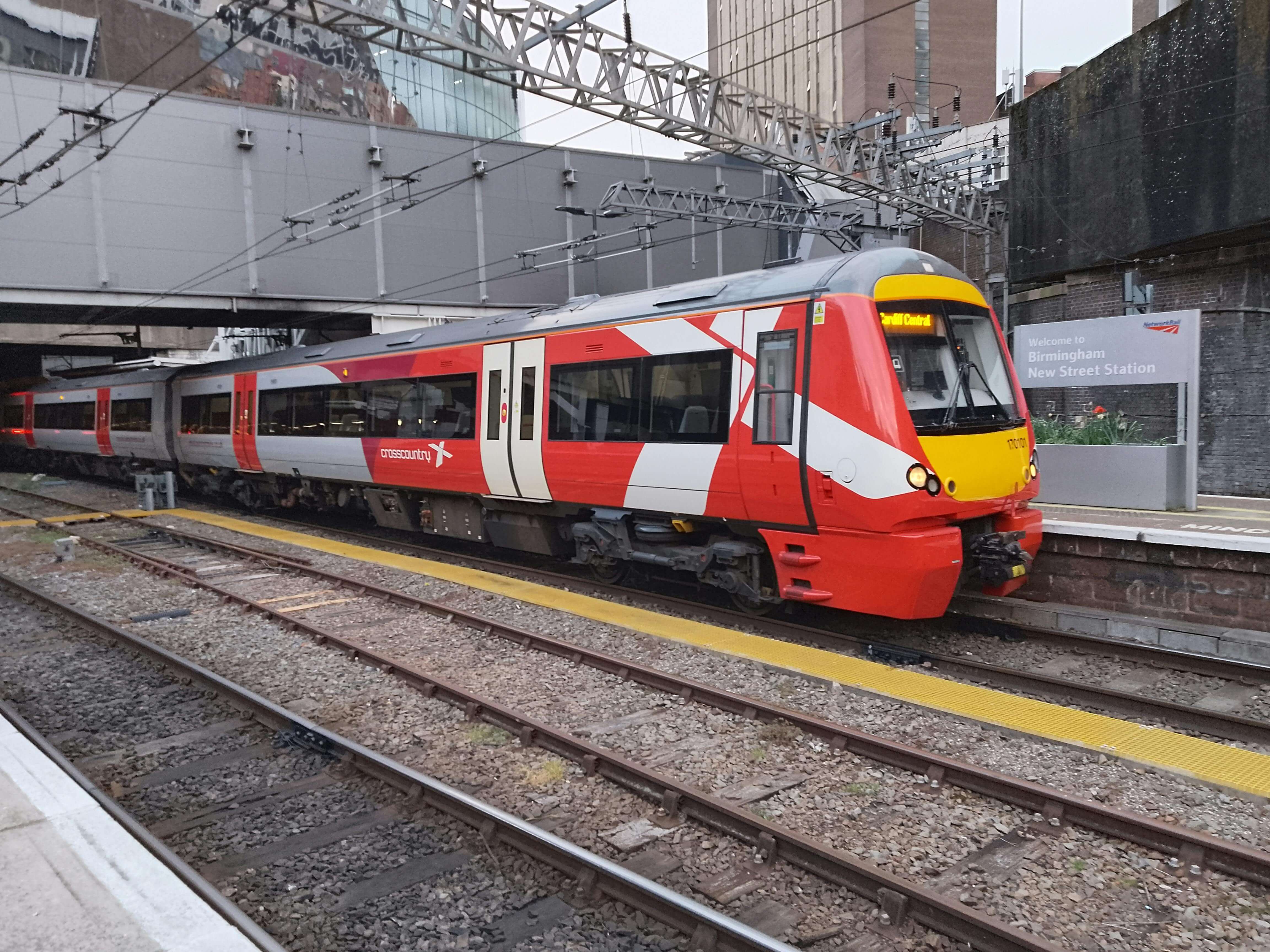 Red and white train at platform in Birmingham New Street Station