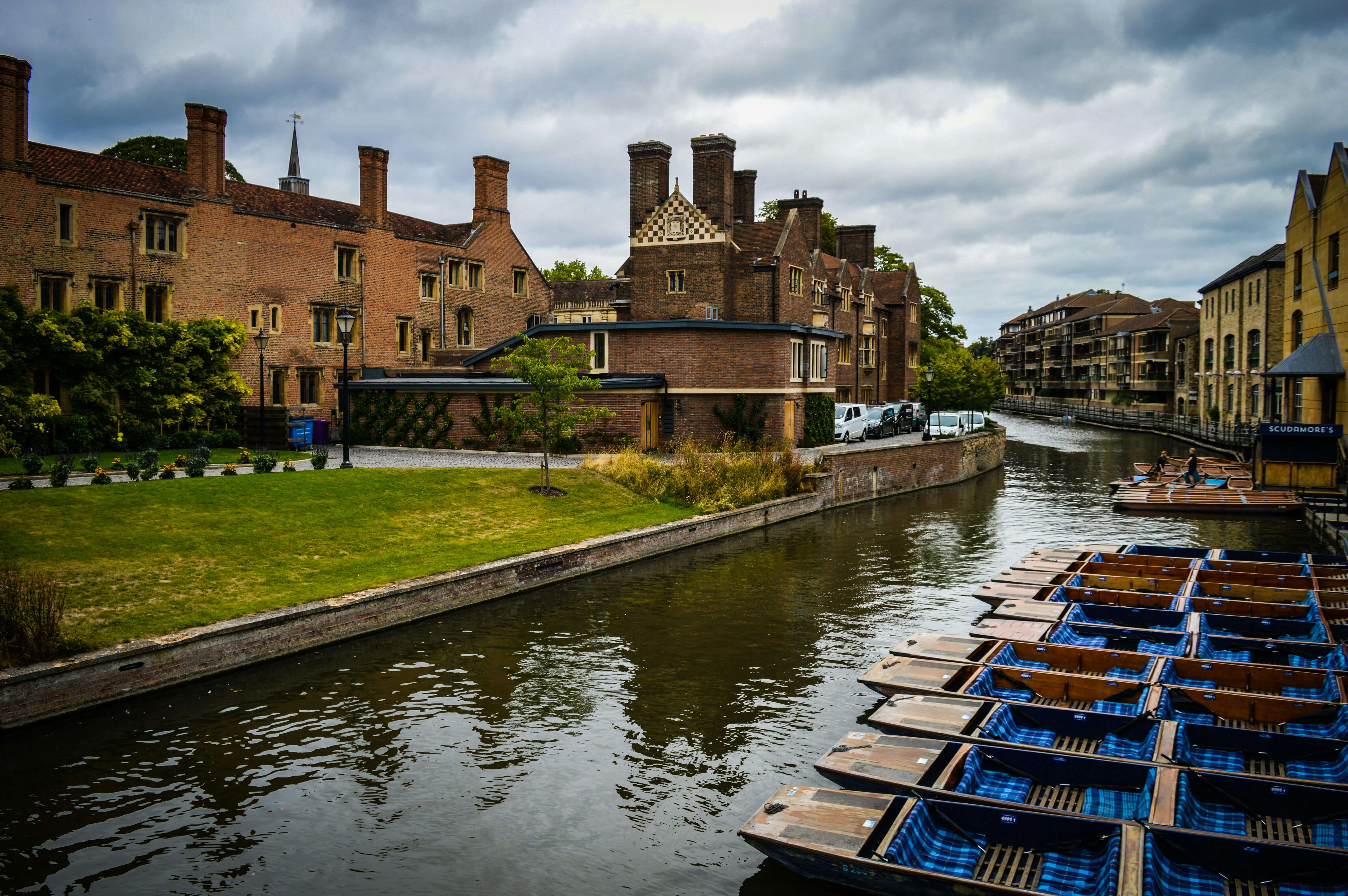 Traditional punts moored on the River Cam with historic Cambridge college buildings