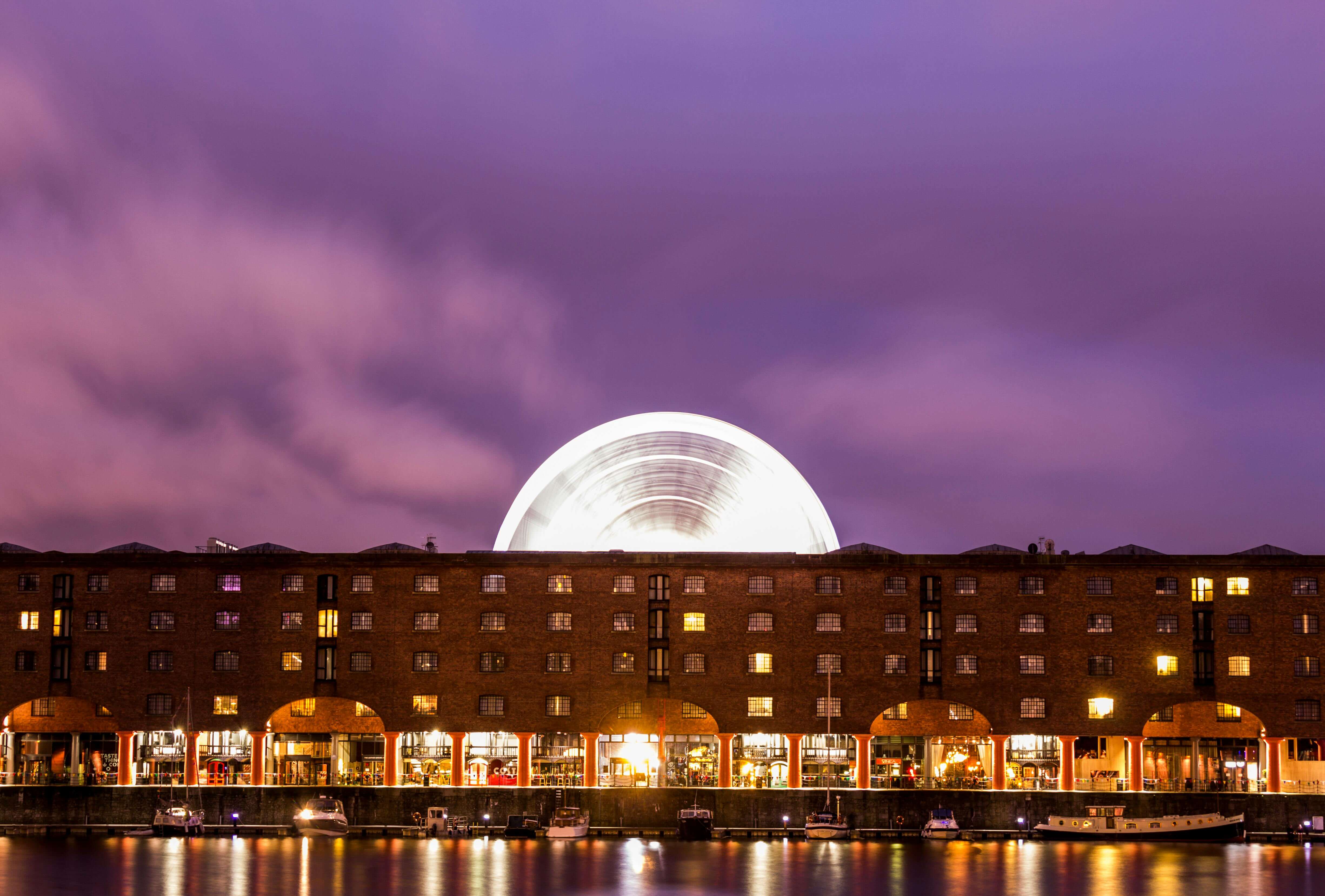Albert Dock converted warehouses at twilight with ferris wheel, Liverpool