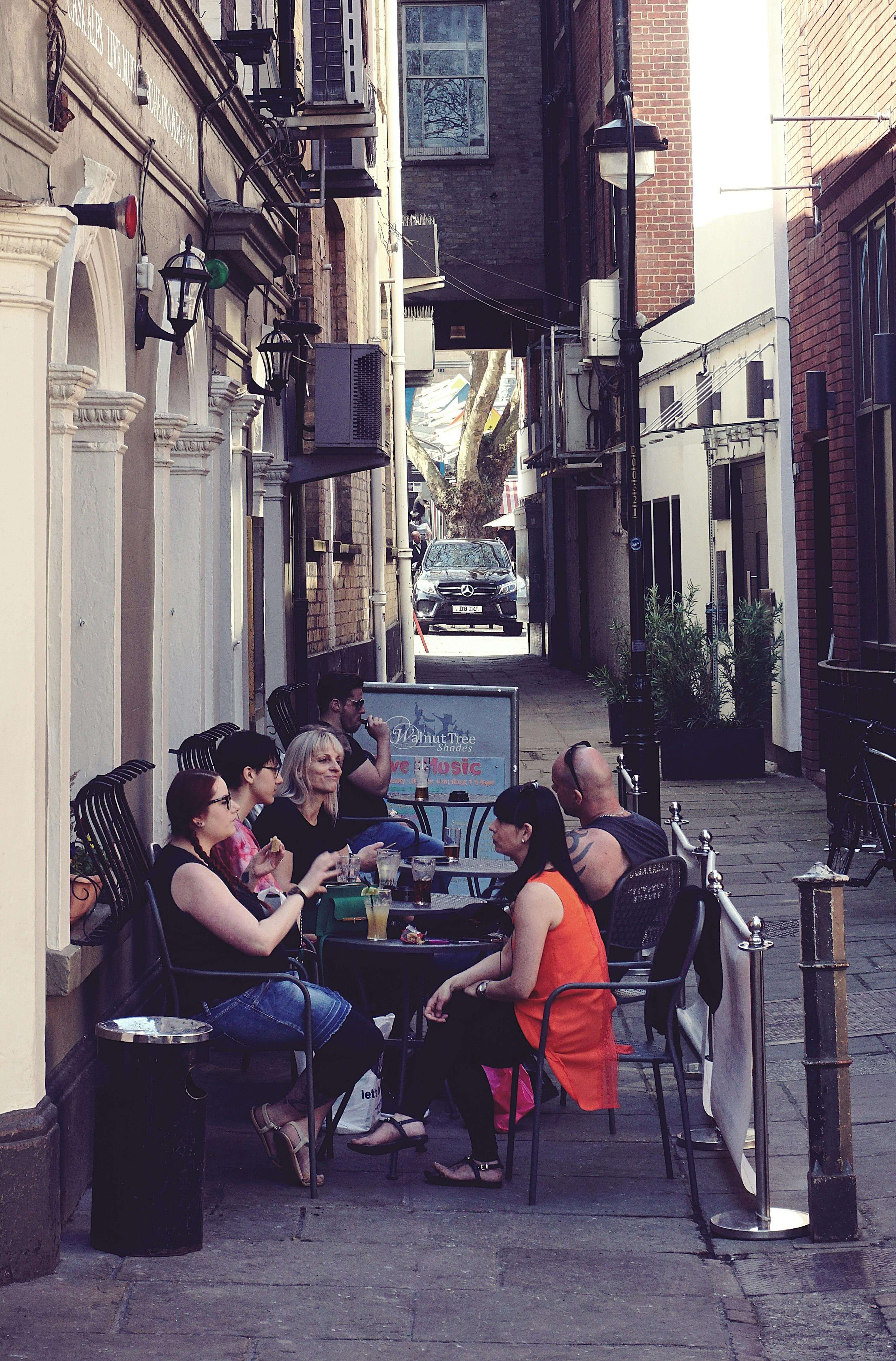 Outdoor cafe seating in historic Norwich Lanes narrow alleyway