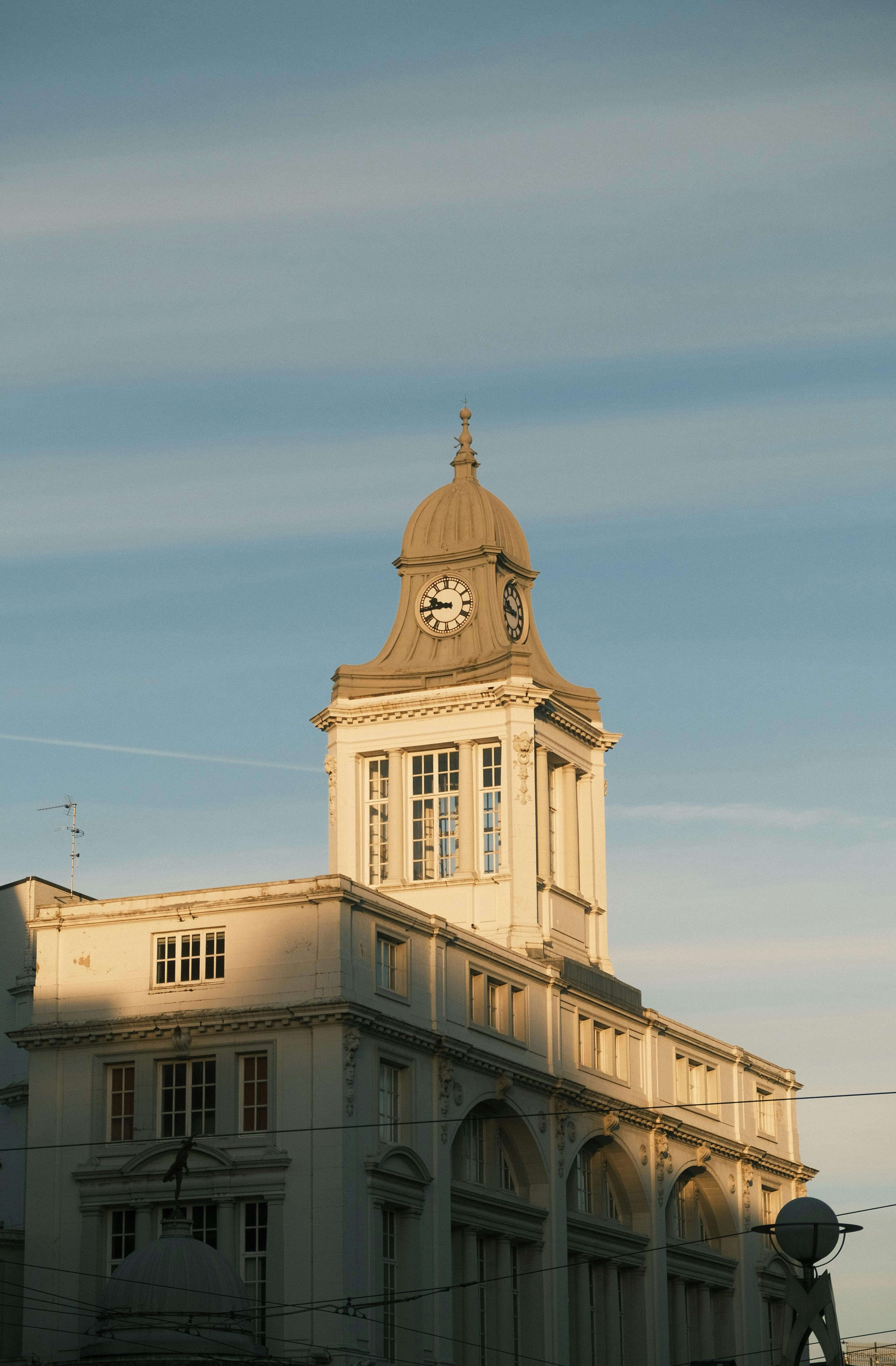 Sheffield Town Hall clock tower illuminated in golden evening light